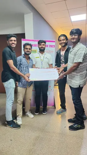 Team members receiving a sponsorship cheque from a partner.