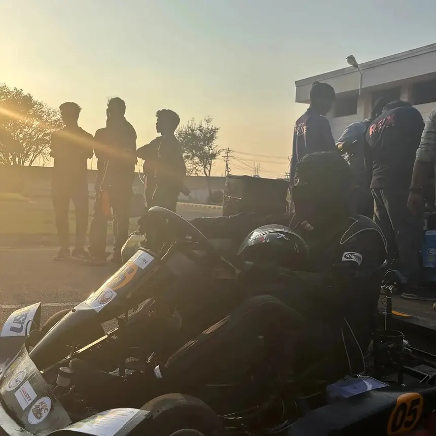 The kart silhouetted against a low sun at the end of a test day.
