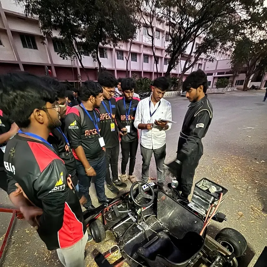 The team gathered around the kart during scrutineering at Kari Motor Speedway.
