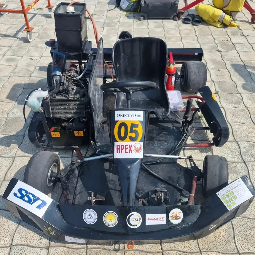 The Apex Racing EV kart on its wheels in the FKDC paddock, number 05 on the nose plate.