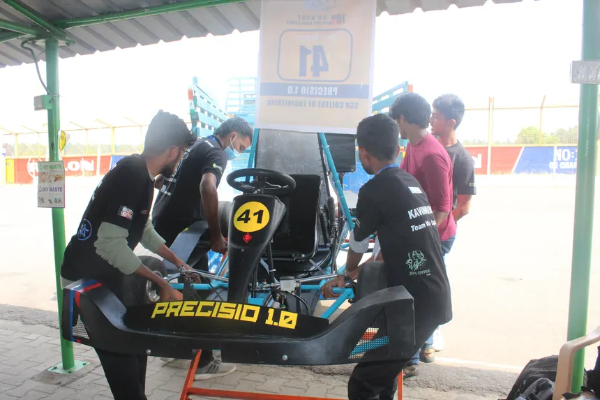 The crew working on the Precisio kart in the pit garage.