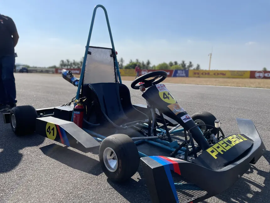 The Precisio combustion kart, number 41, parked on the circuit apron.